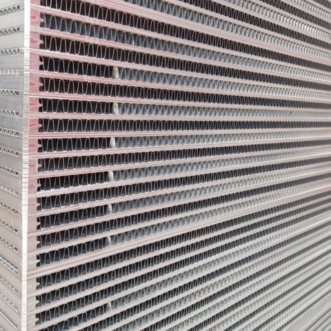 Close-up of a heavy-duty aluminium plate-and-bar hydraulic oil cooler core with wide fins